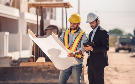 civil-engineer-construction-worker-manager-holding-digital-tablet-blueprints-talking-planing-about-construction-site-cooperation-teamwork-concept